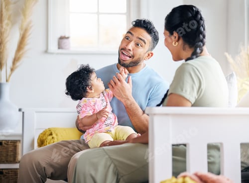 Preview: She loves dads silly faces. Shot of a young family spending time together at home.