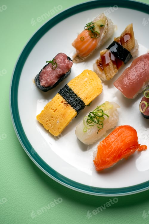 Preview: Sushi platter, a selection of raw fish and rice snacks with chopsticks.