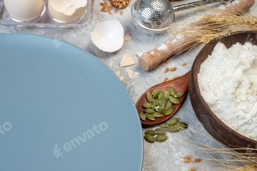 Preview: bottom view round plate eggs in viol wooden spoon flour bowl rolling pin on table