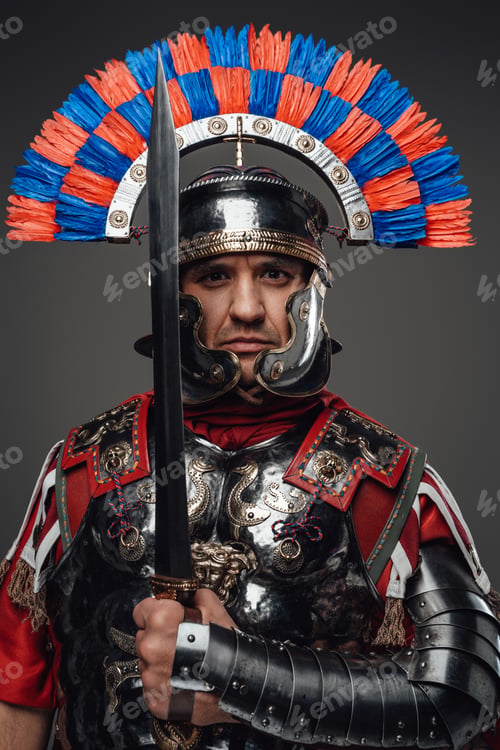 Preview: Proud roman soldier with gladius posing against gray background