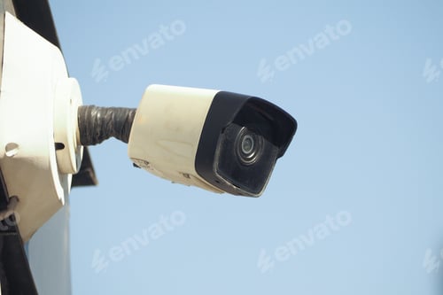 Preview: Security camera mounted on wall in clear sky