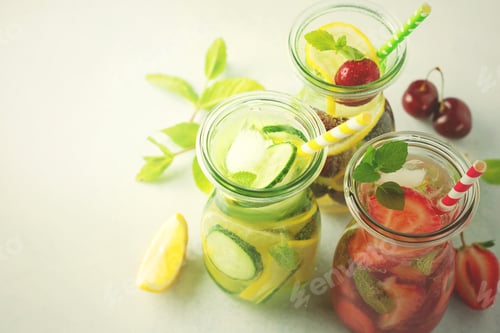 Preview: Refreshing summer homemade cocktail in glass bottles. Detox fresh water. Selective focus. Copy space