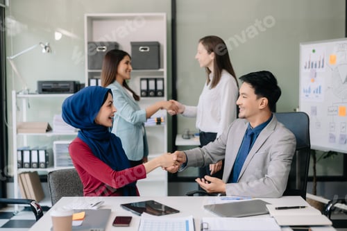 Preview: Business partnership handshake concept.Photo two coworkers handshaking process.