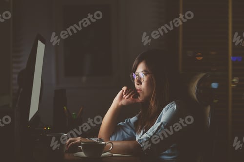 Preview: Portrait of Asian Businesswoman sitting and working hard on the table with front of computer