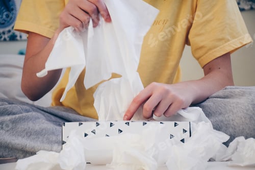 Preview: Girl using facial tissues. Cold, flu and allergy season