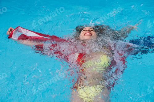 Preview: Woman inside the pool enjoying happy with American flag
