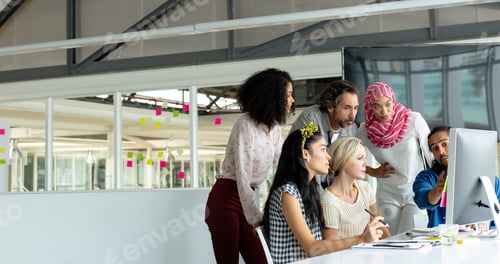 Preview: Diverse business people working together on computer