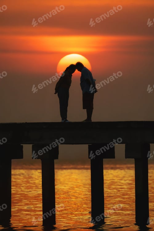 Preview: Vertical of a romantic couple on a dock, posing at sunset in Bangkok, Thailand