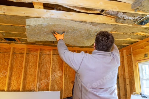 Preview: Man installs insulation panels on ceiling during home renovation project in a single-family house