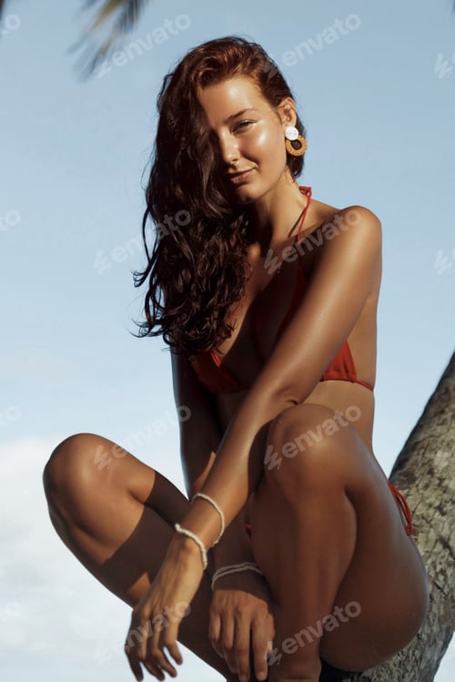 Preview: Beauty and Fashion Photoshoot of Tanned Bikini Beach Girl Model in Swimsuit at Palm Tree