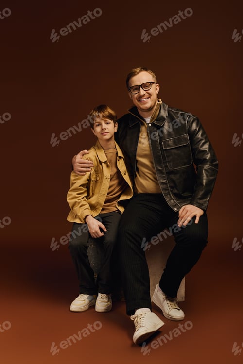 Preview: Father and son share joyful moments in stylish casual outfits during studio session