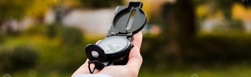 Preview: panoramic shot of woman holding retro compass