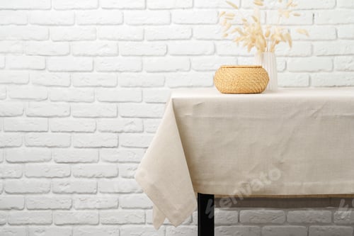 Preview: White Brick Wall With Beige Tablecloth and Basket