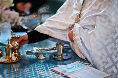 Preview: Hand of priest at rite of baptism.