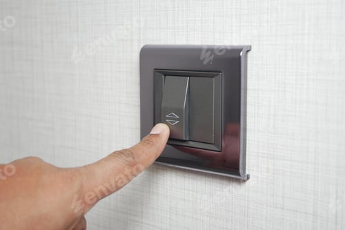 Preview: A finger turning on lighting switch .