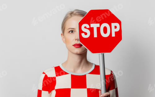 Preview: Beautiful woman with blond hair in in a 70s red square dress with stop sign