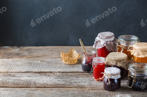 Preview: Assortment of seasonal berries and fruits jams in jars