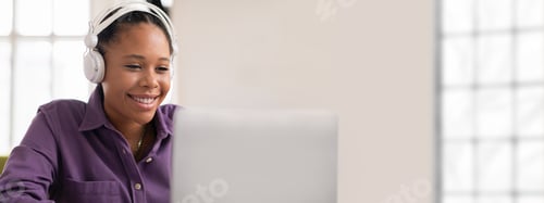 Preview: Young woman engaged in a virtual meeting at a bright office space