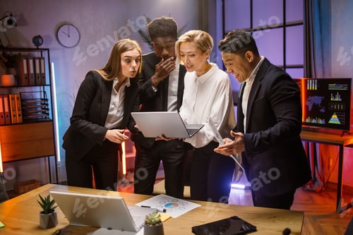 Preview: Colleagues looking at laptop screen and smiling. Good job