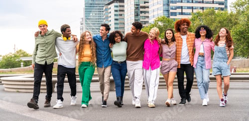 Preview: Happy playful multiethnic group of young friends bonding outdoors