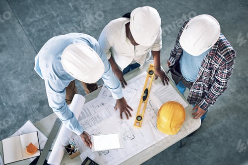 Preview: Shot of a group of builders having a meeting at a construction site