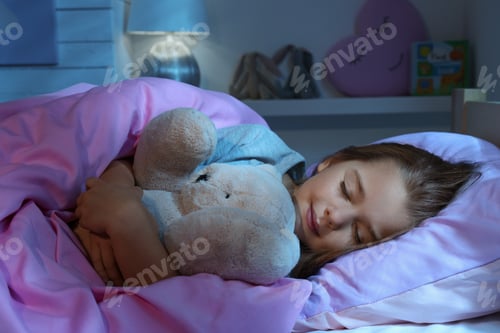 Preview: Cute little girl with toy bear sleeping in bed at home