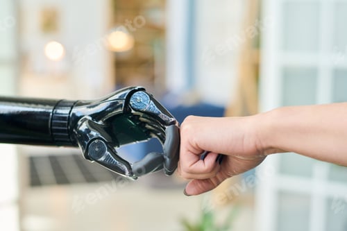 Preview: Black myoelectric hand and that of young female during punch bump
