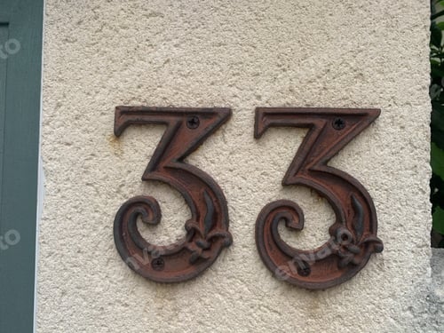 Preview: Closeup shot of number 33 in the address on the building wall