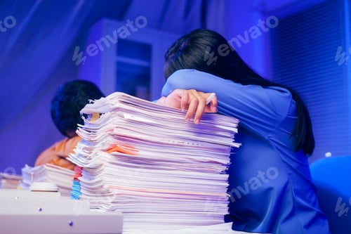 Preview: A businessman and woman are working overtime their desks in office,exhausted and sleepy.overloaded