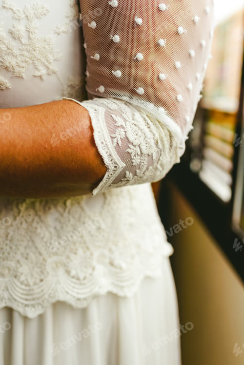 Preview: Elbow of a woman with wedding dress.
