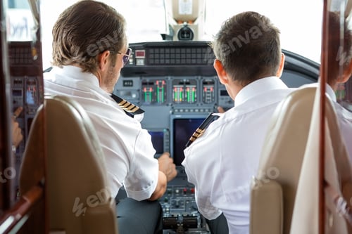 Preview: Pilot And Copilot In Private Jet Cockpit