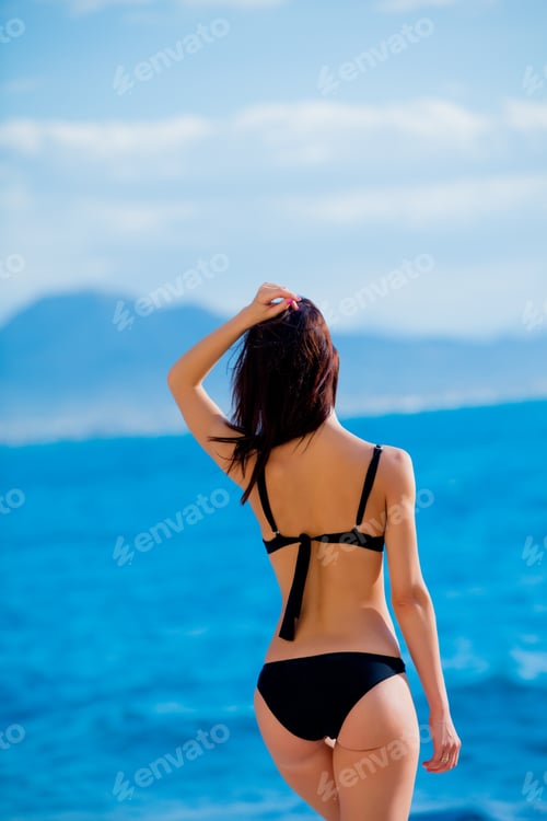 Preview: beautiful young woman standing in front of wonderful sea background in Greece