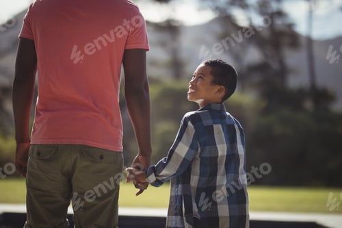 Preview: Father and son standing near poolside