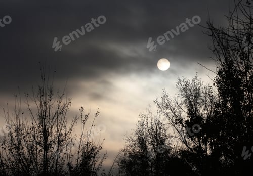 Preview: Morning Sun Through Clouds - Photograph Of An Eerie And Dramatic Morning Sun Low On The Horizon And