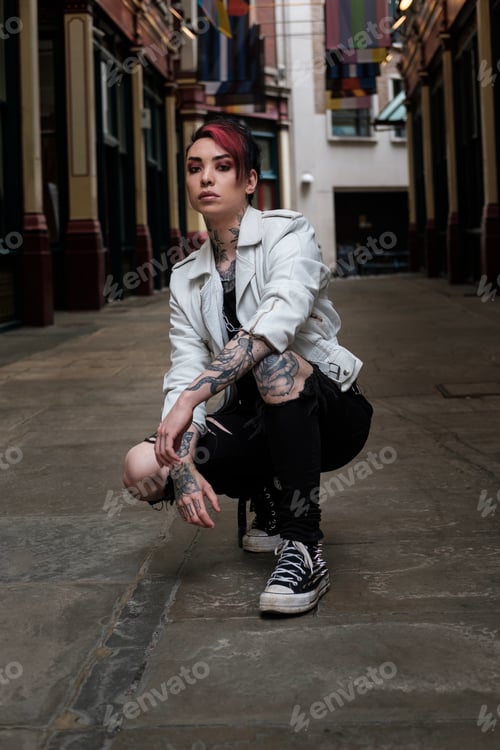 Preview: Alternative non-binary male sitting on squat position.