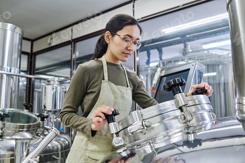 Preview: Female young engineer working on equipment
