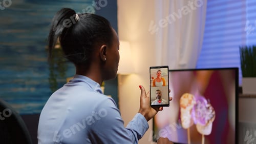 Preview: Black woman remote entrepreneur having video conference with friends