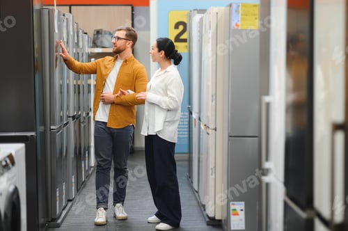 Preview: couple, satisfied customers choosing fridge in appliances store