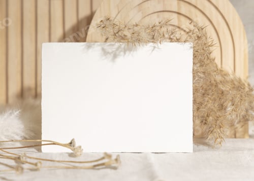 Preview: Blank card near dry pampas grass and beige wooden decor on linen closeup, minimal mockup