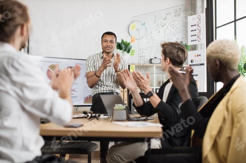 Preview: Focus on clapping hands of multi ethnic male partners in formal clothes