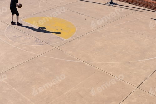 Preview: Cropped shot of man shooting practicing his basketball skills.
