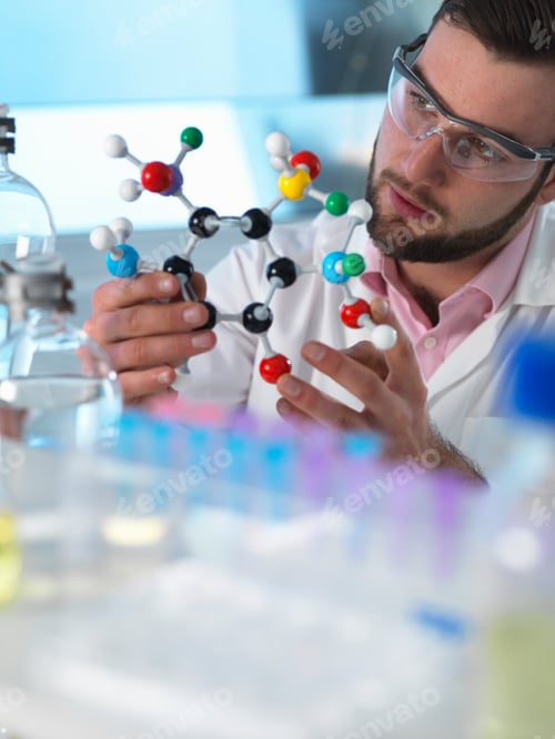 Preview: Scientist examining molecular model structure in laboratory