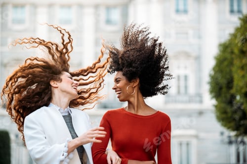 Preview: Two cheerful young women walking together
