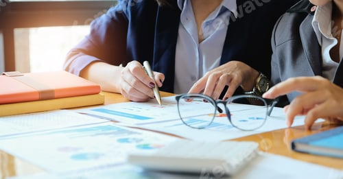 Preview: Two accountant discussion analysis sharing calculations about the company budget and financial
