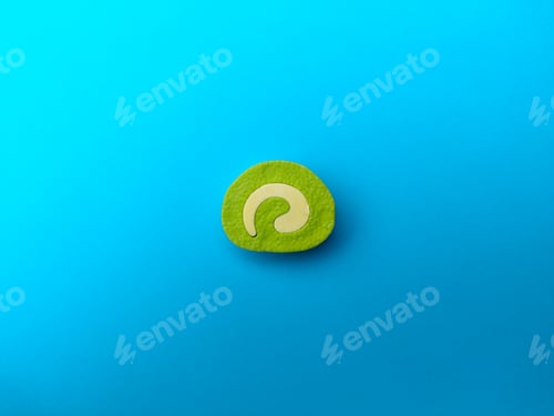 Preview: A piece of green cake on a blue background