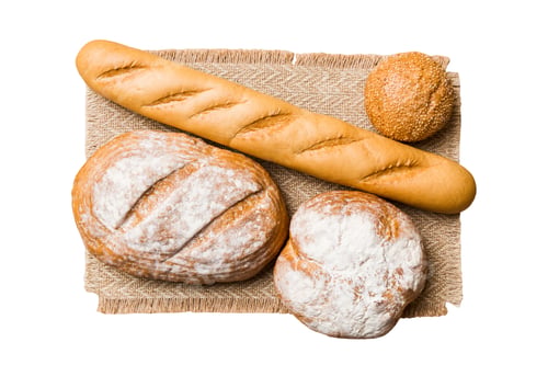 Preview: Freshly baked delicious french bread with napkin isolated on white background top view.