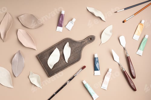 Preview: Hobby background with handmade clay leaves, paint brushes and art accessories