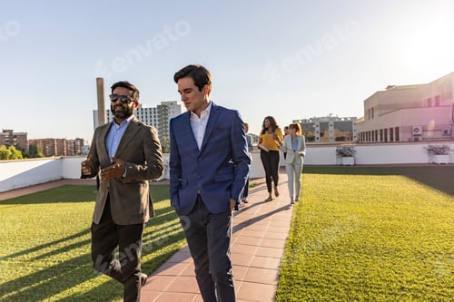 Preview: business colleagues walking outdoors, multiracial