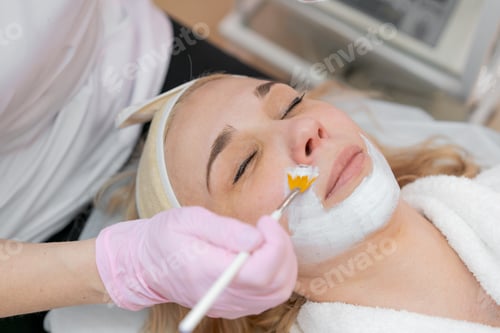 Preview: Facial peeling mask, beauty spa, skin care. Woman getting facial treatment