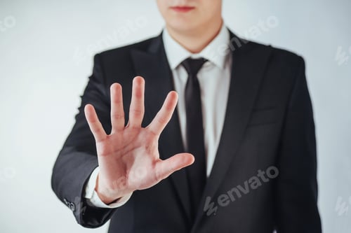 Preview: Young businessman in a suit shows his hand